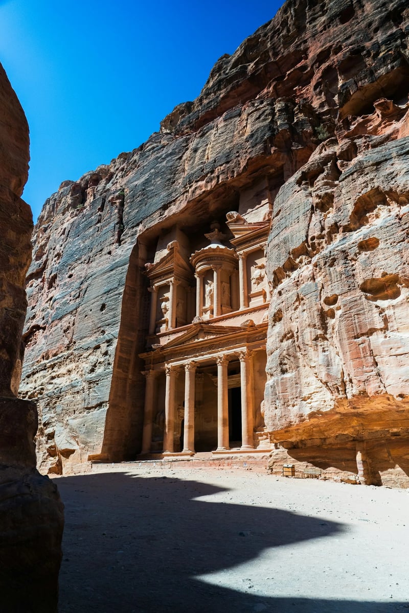 The Treasury carved into sandstone cliffs at Petra, Jordan