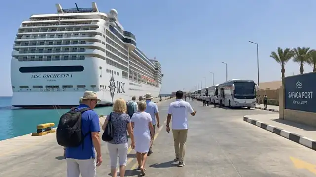 Cruise guests walking with their guide to coaches at Safaga port